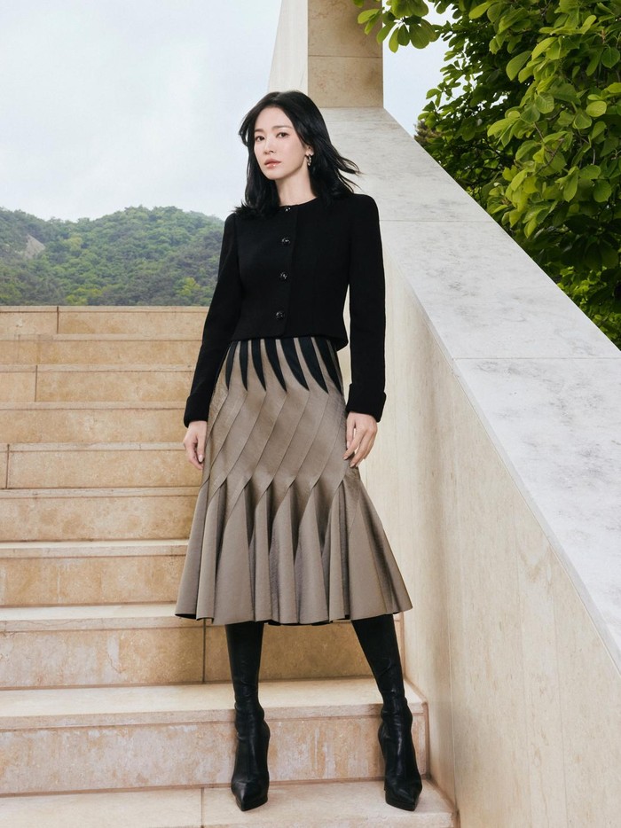 Sang aktris banyak menggunakan fashion item seperti boots berbahan kulit, atasan berupa blouse hingga kemeja lengan panjang, serta rok midi yang modis./ Foto: Mok Jung Wook/instagram.com/kyo1122