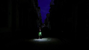 A man uses his phone's flashlight to light his way while walking on a street as Cuba's national electric grid collapsed at midday, leaving around 10 million people without power, in Havana, Cuba, July 6, 2026. REUTERS/Norlys Perez