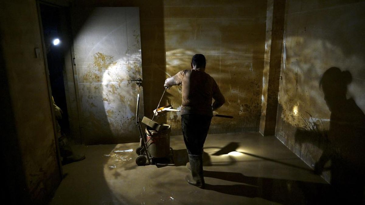 Residents clean mud from a house in Gantang after it was flooded when a nearby reservoir collapsed in Chinaís southwest Guangxi region on July 9, 2026. The death toll from devastating floods in southern China's Guangxi region rose to 39 on July 9, w