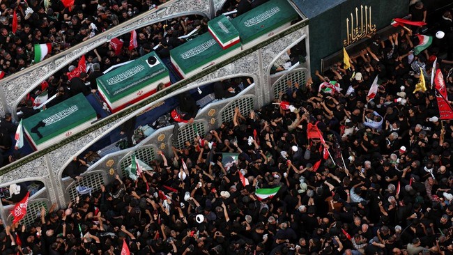 Mourners gather around a vehicle transporting the coffin of Iran's late Supreme Leader Ayatollah Ali Khamenei, who was killed on February 28 in Israeli and U.S. airstrikes, and coffins of his family members, on the day of his burial, in a culmination