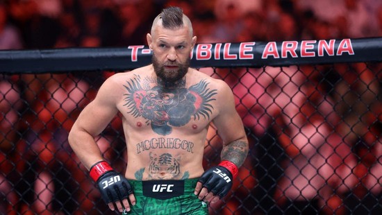 Jul 11, 2026; Las Vegas, Nevada, USA; Conor McGregor (red gloves) fights Max Holloway (blue gloves) in a welterweight bout during UFC 329 at T-Mobile Arena. Mandatory Credit: Mark J. Rebilas-Imagn Images