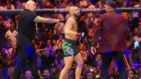 Jul 11, 2026; Las Vegas, Nevada, USA; Conor McGregor (center) reacts after suffering an injury that ended his fight with Max Holloway during UFC 329 at T-Mobile Arena. Mandatory Credit: Mark J. Rebilas-Imagn Images