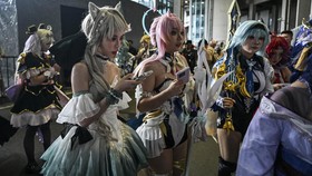 Cosplayers arrive outside the venue of the Bilibili World 2026 in Shanghai on July 12, 2026. (Photo by Hector RETAMAL / AFP)