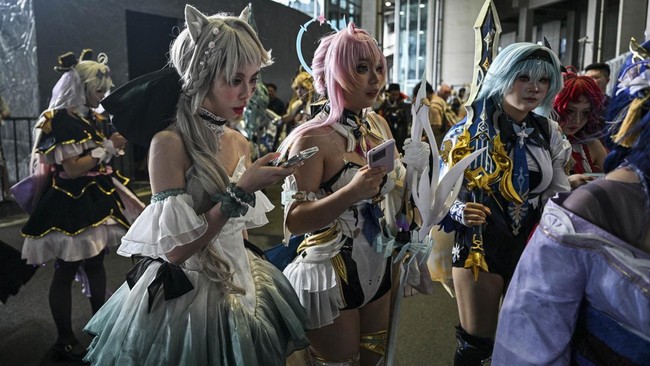 Cosplayers arrive outside the venue of the Bilibili World 2026 in Shanghai on July 12, 2026. (Photo by Hector RETAMAL / AFP)