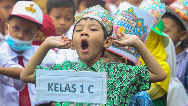 Seorang siswa baru menguap saat mengikuti upacara pada hari pertama tahun ajaran 2026/2027 di SDN Serua 01 Ciputat, Tangerang Selatan, Banten, Senin (13/7/2026). Para orang tua mengantar anak mereka ke sekolah untuk mengenalkan lingkungan belajar ser