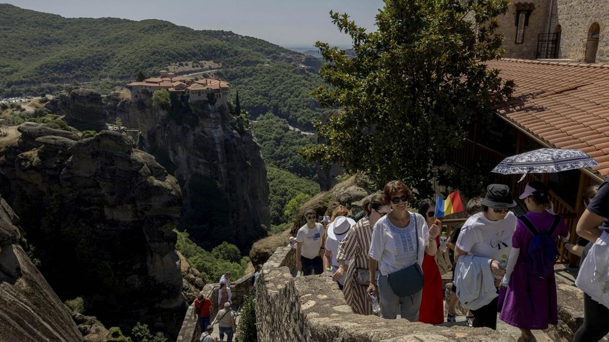 Tourists visit the Monastery of the Great Meteoron at Meteora, near Kalambaka, Greece, July 12, 2026. REUTERS/Louiza Vradi