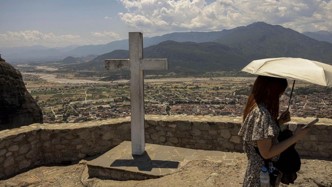 A tourist visits the Monastery of the Holy Trinity at Meteora, near Kalambaka, Greece, July 12, 2026. REUTERS/Louiza Vradi