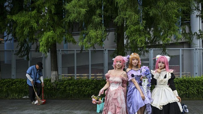Cosplayers pose for pictures outside the venue of the Bilibili World 2026 in Shanghai on July 12, 2026. (Photo by Hector RETAMAL / AFP)