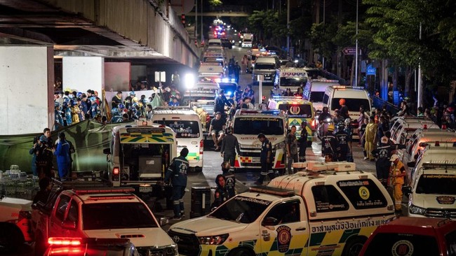 An ambulance is parked outside a bar after a massive fire broke out in Bangkok, early on July 13, 2026. A fire in a bar in the Thai capital Bangkok killed at least 27 people late Sunday night, Prime Minister Anutin Charnvirakul told local media. (Pho