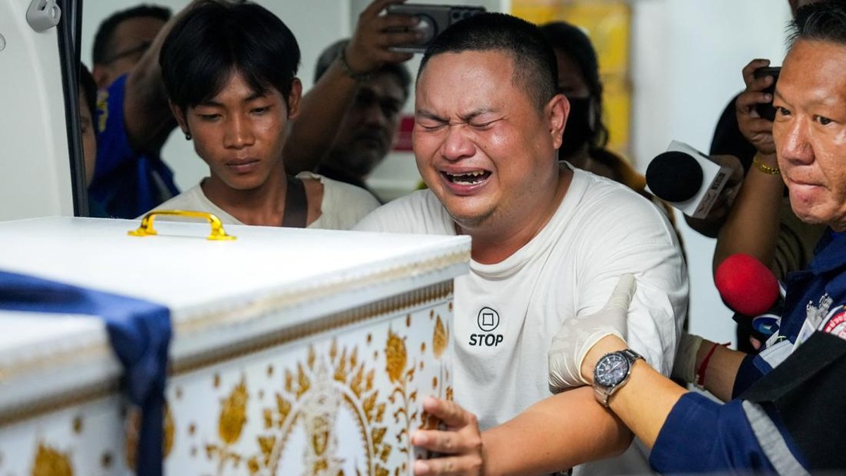 A family member reacts as he receives the body of a victim at the Police Hospital morgue, following a deadly fire at a pub in Bangkok, Thailand, July 13, 2026. REUTERS/Arnun Chonmahatrakool     TPX IMAGES OF THE DAY