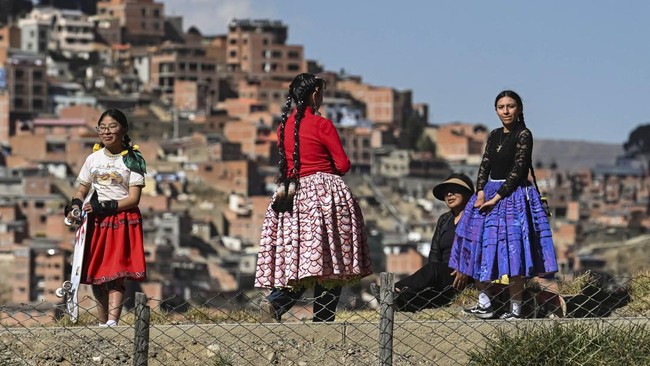Women wearing traditional Cholita attire wait for the start of a Cholita skating competition in La Paz, Bolivia, July 16, 2026. REUTERS/Claudia Morales