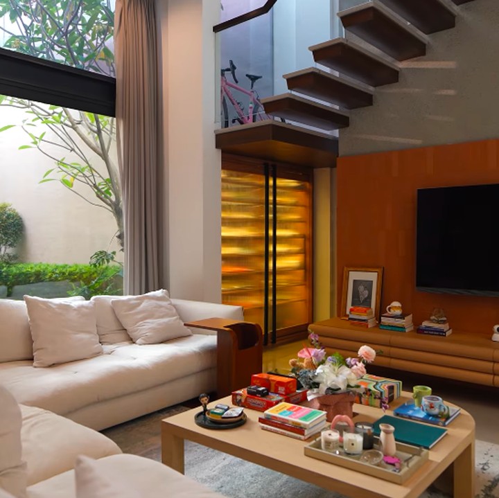 <p>Dalam video tersebut, Pevita memperlihatkan setiap sudut rumah pribadinya yang diberi nama Lovenest. Ia mengawali tur dari area <em>foyer</em> dan <em>living room.</em> Pevita mengaku <em>living room</em> menjadi tempat favoritnya kumpul bersama keluarga dan teman-teman. Bahkan, area ini sering kali dimanfaatkan untuk syuting <em>podcast.</em> &ldquo;Aku sering banget <em>nge-host</em> acara dan ngundang teman-teman dan keluarga kesini, dan biasanya kalau mereka udah ngumpul, kita <em>hangout</em> di ruang tamu ini. Kita juga main <em>board games</em>, nonton, malah sering banget ada orang-orang yang ketiduran di sofa ini,&rdquo; ujar Pevita, dikutip dari kanal <em>YouTube Pevita Pearce</em>, Jumat (17/7/2026).&nbsp; (Foto: YouTube Pevita Pearce)</p>