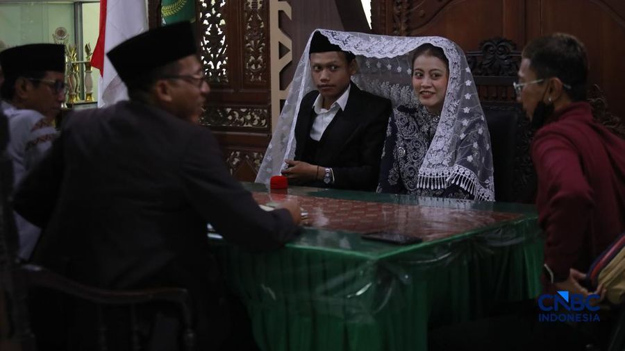 Sepasang calon pengantin Azril 24 tahun dan Julia 23 tahun menjalani prosesi janji nikah di KUA Tebet, Jakarta, Jumat, (17/7/2026). (CNBC Indonesia/Muhammad Sabki)