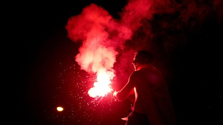Soccer Football - FIFA World Cup 2026 - Final - Spain v Argentina - Fans gather in Madrid - Madrid, Spain - July 20, 2026 Spain fan lights a flare as they celebrate at Plaza de Cibeles in Madrid after Spain win the FIFA World Cup final against Argent
