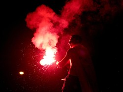 Soccer Football - FIFA World Cup 2026 - Final - Spain v Argentina - Fans gather in Madrid - Madrid, Spain - July 20, 2026 Spain fan lights a flare as they celebrate at Plaza de Cibeles in Madrid after Spain win the FIFA World Cup final against Argent