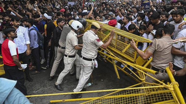 Activists and supporters of the Cockroach Janta Party (CJP) clash with police personnel during a protest demanding the resignation of India's Education Minister Dharmendra Pradhan over alleged NEET examination irregularities in New Delhi on July 20,