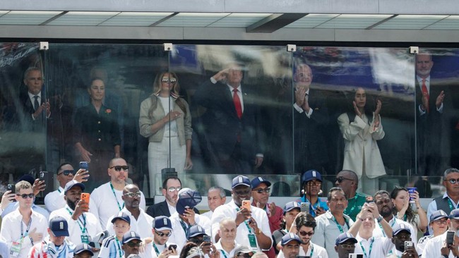 U.S. President Donald Trump salutes next to U.S. first lady Melania Trump, FIFA President Gianni Infantino, Mexican President Claudia Sheinbaum, Canada's Prime Minister Mark Carney and King of Spain Felipe VI during the U.S. national anthem before th