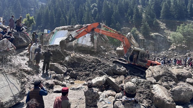 Afghan men clear the rubble of destroyed shops after flash floods hit Parun town in Afghanistan's Nuristan province, on July 21, 2026. At least 20 people have been killed and more than 100 remain missing in flooding that hit Afghanistan's Nuristan pr
