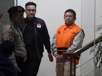 Bupati Lombok Barat Lalu Ahmad Zaini (kanan) berjalan menuju mobil tahanan usai menjalani pemeriksaan di Gedung Merah Putih KPK, Jakarta, Selasa (21/7/2026). KPK menahan tiga orang tersangka pasca operasi tangkap tangan (OTT) pada Senin (20/7) yakni