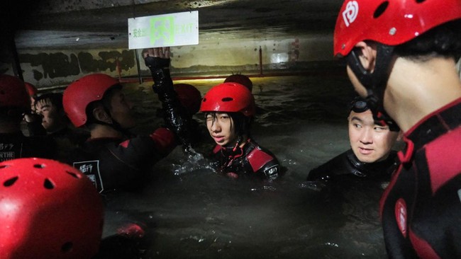 Participants practice evacuating an underground facility during a typhoon survival training session at the Lvxing Disaster Simulation Training Center in Hangzhou, Zhejiang province, China July 15, 2026. REUTERS/Go Nakamura