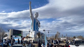 People gather by a statue of Argentina's revered Lionel Messi to watch the World Cup semi-final between Argentina and England, in Cutral Co, in the Patagonian province of Neuquen, Argentina, July 15, 2026. REUTERS/Leila Miller