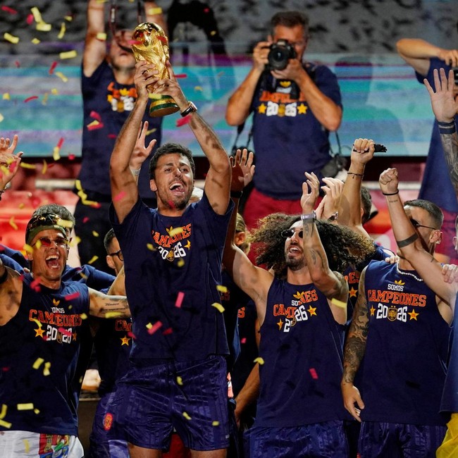 Soccer Football - FIFA World Cup 2026 - Spain Victory Parade - Madrid, Spain - July 20, 2026 Spain's Rodri celebrates with the World Cup trophy and teammates on stage at Cibeles Square in Madrid after the victory parade as fans gather to celebrate wi