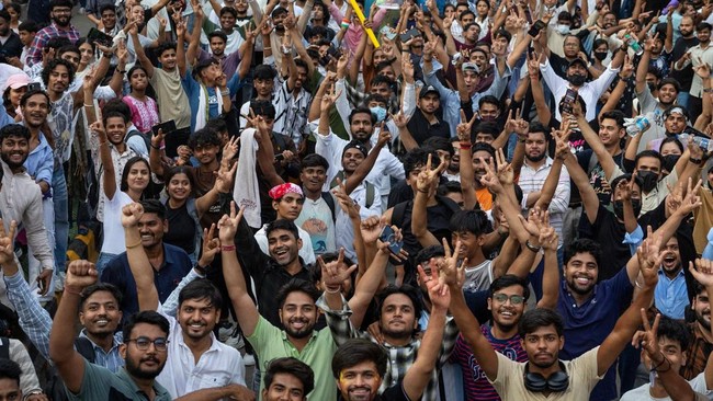 Supporters of India's Cockroach Janta Party (CJP) celebrate after India's Education Minister Dharmendra Pradhan resigned following days of protests demanding his resignation over National Eligibility cum Entrance Test (NEET) examination paper leaks,