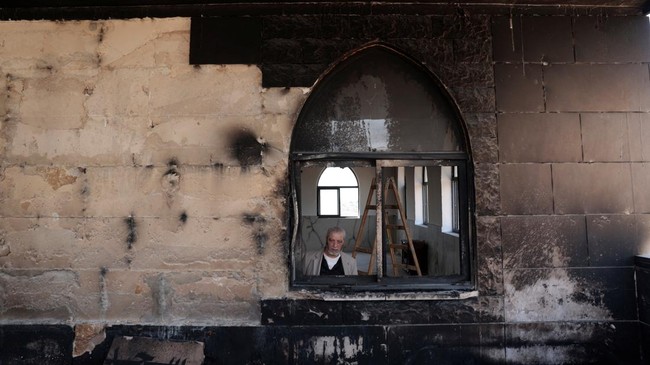 A Palestinian man inspects the damage at a mosque, which Palestinians say was damaged by Israeli settlers, in Qusra near Nablus, in the Israeli-occupied West Bank, July 26, 2026. REUTERS/Mohamad Torokman