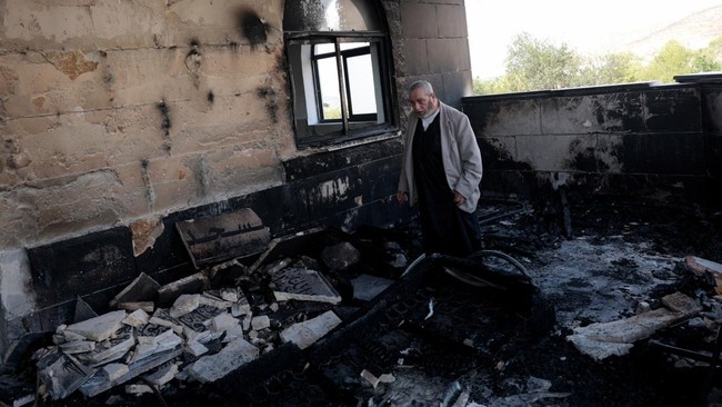 A Palestinian man inspects the damage at a mosque, which Palestinians say was damaged by Israeli settlers, in Qusra near Nablus, in the Israeli-occupied West Bank, July 26, 2026. REUTERS/Mohamad Torokman