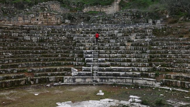 A boy walks in the amphitheatre at the archaeological site of Sebastia, west of the occupied West Bank city of Nablus on February 12, 2026. Israeli cultural watchdog Emek Shaveh denounced on November 24 on 2025, a decision to expropriate nearly 500 a