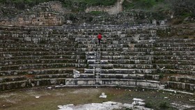 A boy walks in the amphitheatre at the archaeological site of Sebastia, west of the occupied West Bank city of Nablus on February 12, 2026. Israeli cultural watchdog Emek Shaveh denounced on November 24 on 2025, a decision to expropriate nearly 500 a