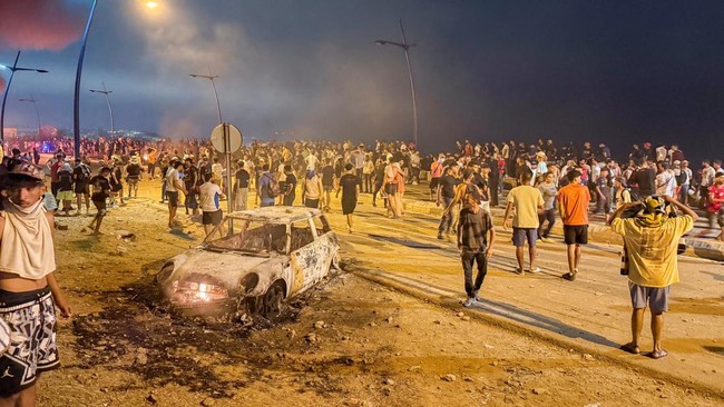 Migrants gather as they wait for a chance to cross to the Spanish enclave of Ceuta, on the Moroccan side of the border in Fnideq, Morocco, July 31, 2026. Picture taken with a mobile phone. REUTERS/Stringer