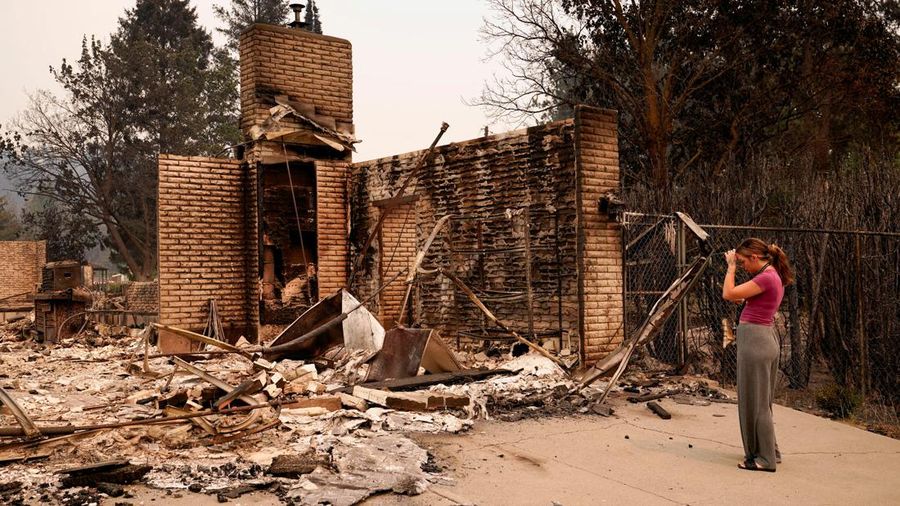 Ash Sollie berdiri di depan rumah kakek-neneknya, tempat dia tinggal sebelumnya, setelah rumah itu hancur akibat kebakaran hutan, di Spokane, Washington, AS, 2 Agustus 2026.