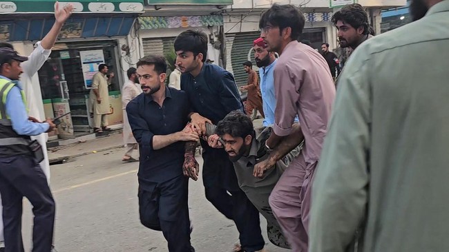 People evacuate an injured victim following a suicide bombing during a protest in Pakistan's Swat district on August 2, 2026. A suicide bomber attacked a busy area near a police station during a protest in northern Pakistan's Swat district, killing s