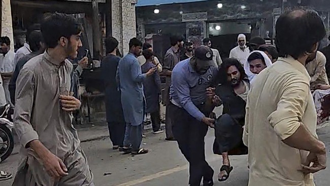 People evacuate injured victims following a suicide bombing during a protest in Pakistan's Swat district on August 2, 2026. A suicide bomber attacked a busy area near a police station during a protest in northern Pakistan's Swat district, killing sev