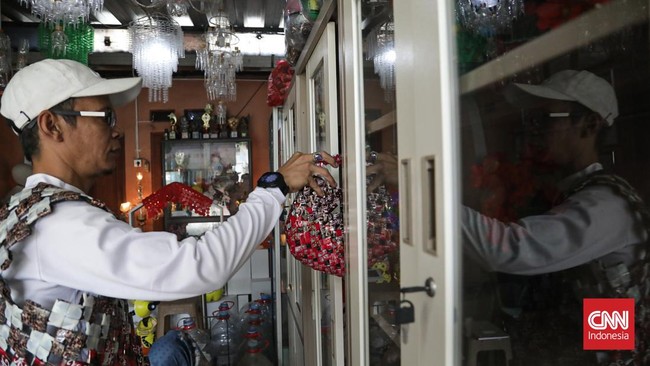 Sejumlah warga membuat kerajinan tangan dari sampah di Bank Sampah Persatuan, Duren Sawit, Jakarta, Senin (3/8). (CNN Indonesia/Febria Adha L).
