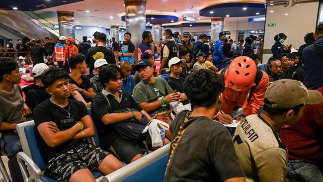 Survivors of the Mutiara Sentosa 2 ferry which caught fire in the waters off Madura island, East Java, on August 2, 2026, gather at Tanjung Perak port in Surabaya early on August 3, 2026. An Indonesian ferry caught fire at sea on Sunday, killing five