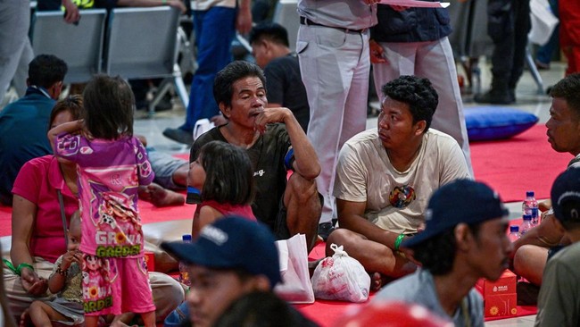 Survivors of the Mutiara Sentosa 2 ferry which caught fire in the waters off Madura island, East Java, on August 2, 2026, gather at Tanjung Perak port in Surabaya early on August 3, 2026. An Indonesian ferry caught fire at sea on Sunday, killing five