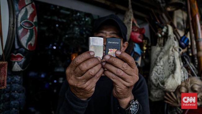 Seorang pedagang memamerkan koleksi korek api lawas di Pasar Barang Antik Jalan Surabaya, Menteng, Jakarta. (CNN Indonesia/Febria Adha L).