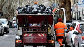 (FILES) This illustration picture shows an employee of Rome's garbage collection "Ama" getting on his truck on January 11, 2018 in Rome. A one-million-euro lottery ticket was found in the rubbish in Italy after the panicked winner asked binmen to hel