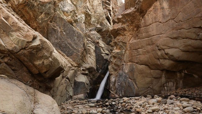 A waterfall flows through a narrow rock gorge in Wadi Wurayah National Park, in Fujairah, United Arab Emirates, July 16, 2026. REUTERS/Amr Alfiky