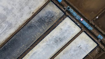 A drone view shows crystallised salt on the pond floors during harvest in Pengarengan village, Cirebon, West Java province, Indonesia, July 30, 2026. REUTERS/Willy Kurniawan