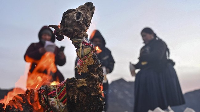 A llama fetus is consumed by fire while Aymara spiritual leaders perform rituals during ceremonies for the Month of Pachamama, as Bolivians make offerings to Mother Earth to seek health, prosperity and good harvests, in La Cumbre, on the outskirts of
