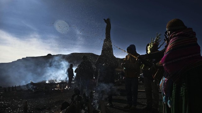 An Aymara spiritual leader pours beer over an offering during ceremonies for the Month of Pachamama, as Bolivians make offerings to Mother Earth to seek health, prosperity and good harvests, in La Cumbre, on the outskirts of La Paz, Bolivia, August 1