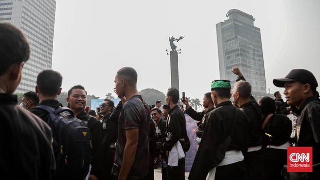 Sejumlah pesilat dari berbagai perguruan mengikuti kerumun kilas saat Hari Bebas Kendaraan Bermotor (HBKB) di Bundaran HI, Jakarta, Minggu (9/8). (CNN Indonesia/Febria Adha L)