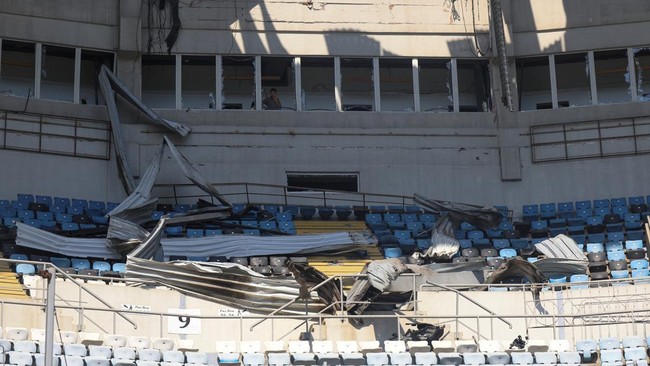 A man looks at damage to the Chornomorets Stadium, which was hit by a Russian drone strike, amid Russia's attack on Ukraine, in Odesa, Ukraine, August 7, 2026. REUTERS/Nina Liashonok