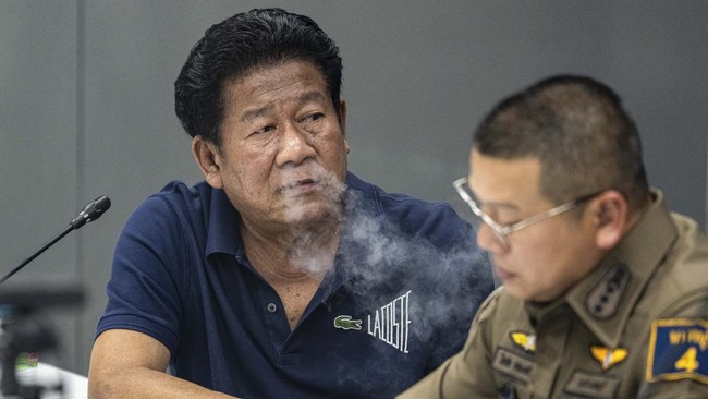 Former lawmaker Chalong Riewrang reacts as he is questioned by police officers after he allegedly shot and killed Thongchai Yenprasert, president of the Nonthaburi Provincial Administrative Organisation, in Nonthaburi province, on the outskirts of Ba