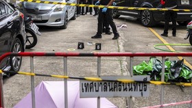 Forensic police officers inspect the site of a shooting after former lawmaker Chalong Riewrang allegedly shot Thongchai Yenprasert, president of the Nonthaburi Provincial Administrative Organisation, in Nonthaburi province, on the outskirts of Bangko