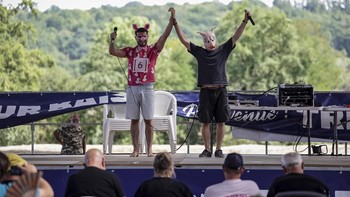 Participants in the French pig-squealing championship perform on stage at the 43rd edition of the Pig Festival, in Trie-sur-BaÔse, south-western France, on August 9, 2026. (Photo by Valentine CHAPUIS / AFP)