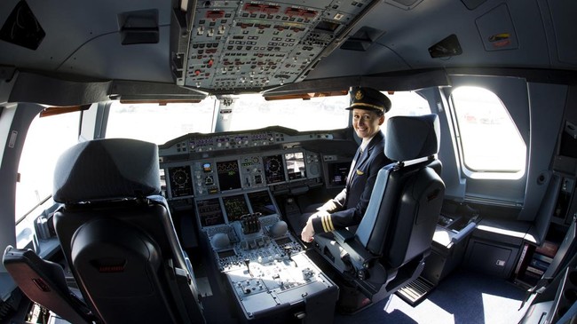 Co-pilot Angelika Barufke poses in the cockpit of an Airbus A380 from Emirates airlines during the International Air Show ILA in Schoenefeld near Berlin on May 21, 2014. According to the organisers, 1,203 exhibitors from 40 countries will attend the